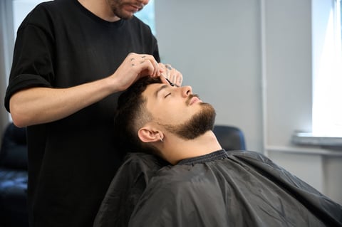 Barber applying wax