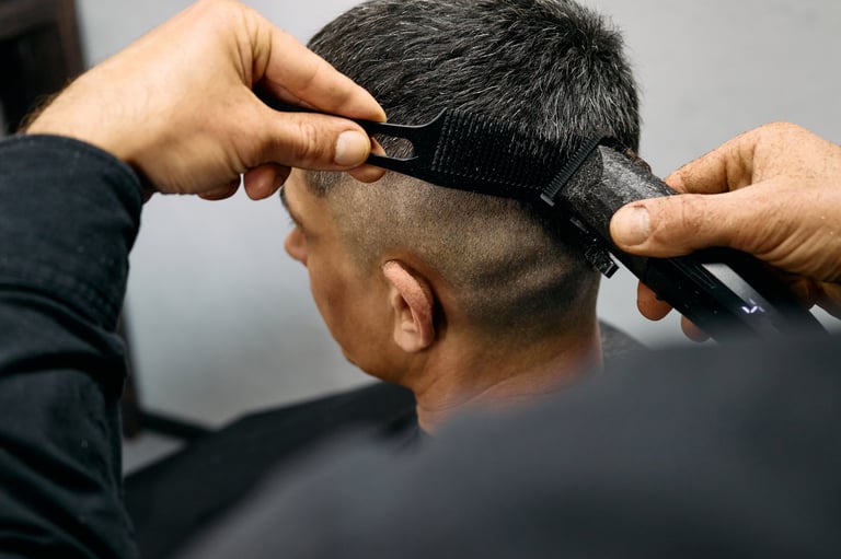 Expert barber cutting hair with clippers